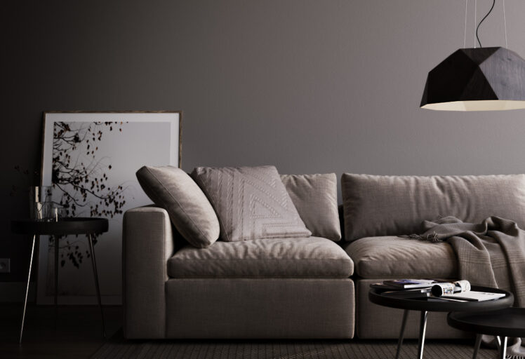 Living room couch and coffee table with low handing light.